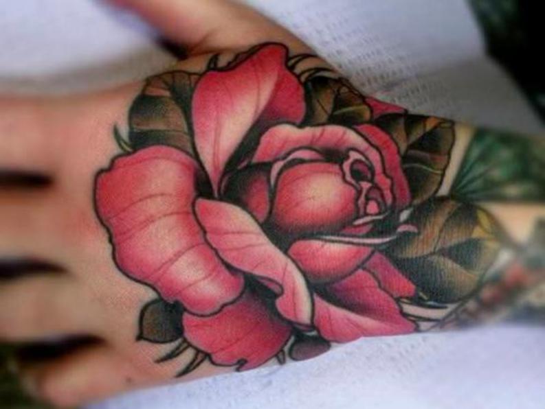 colorful tattoos of roses on the hand