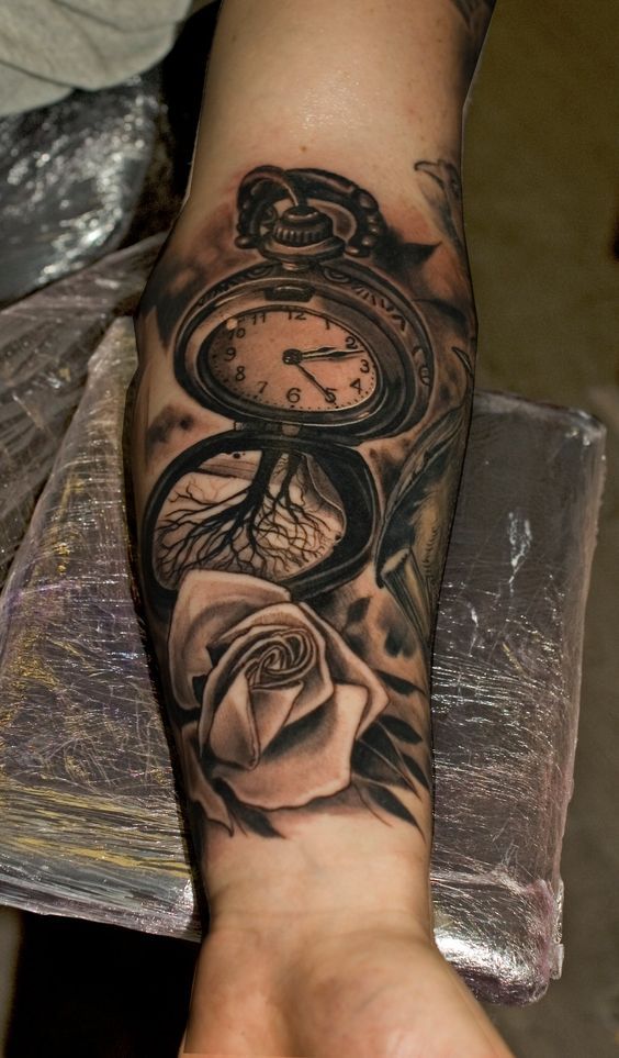 tattoo with roses on the arm and watch