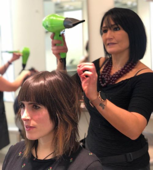 Hairdresser combing half hair