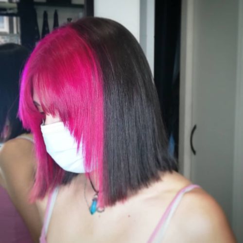 Woman with half black and pink two-tone hair