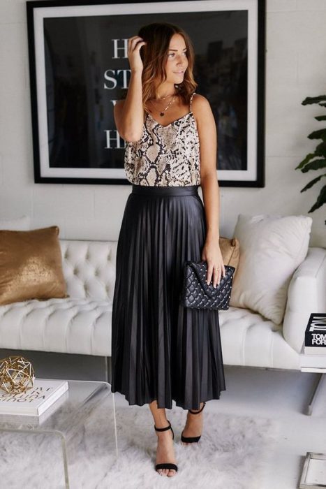 animal print blouse and black pleated skirt