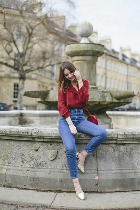 red blouse and worn jeans
