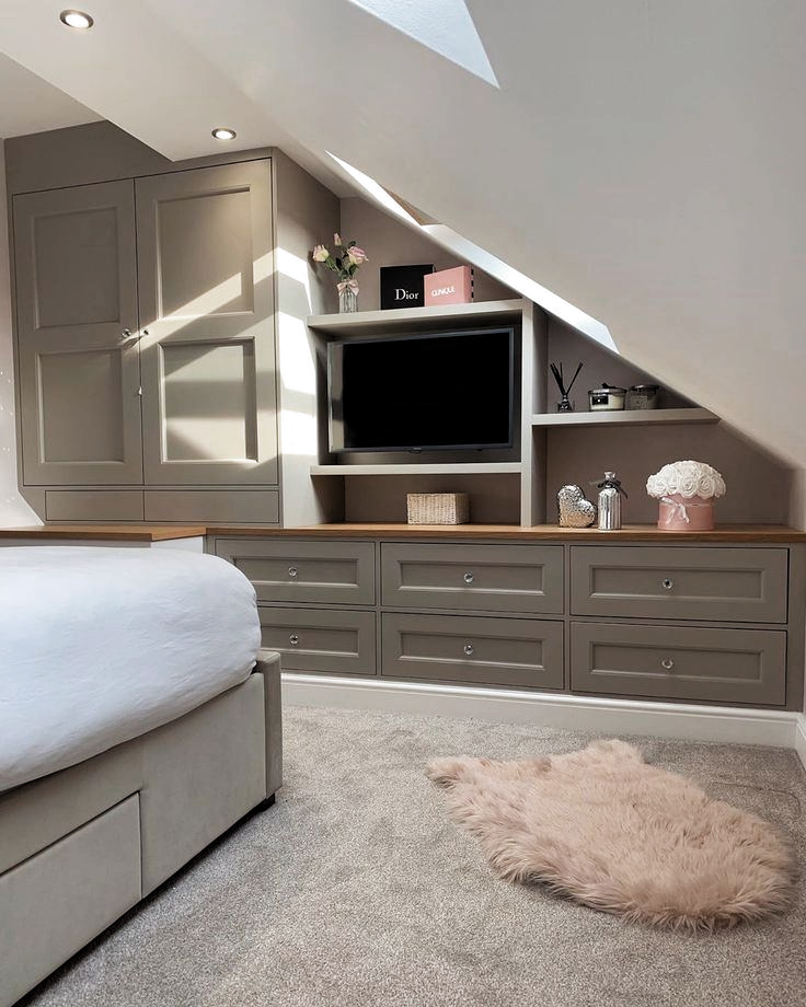 loft room with bookshelves and tv