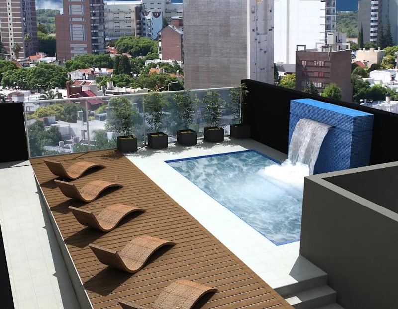 Swimming pool with artificial waterfall