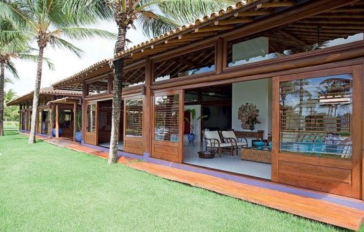 wood and glass cottages in front