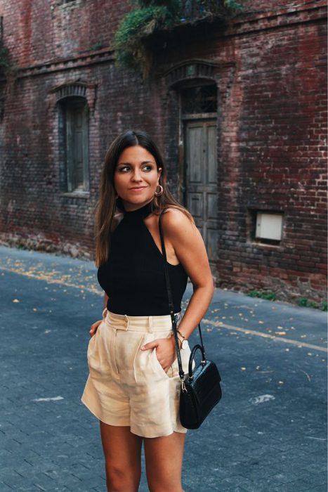 black top and beige shorts