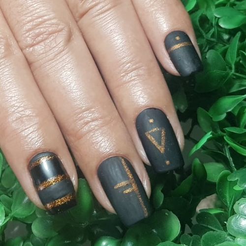 Dark green nails with gold accents